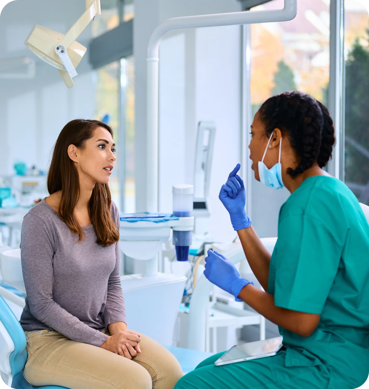 Dentist consulting patient in clinic